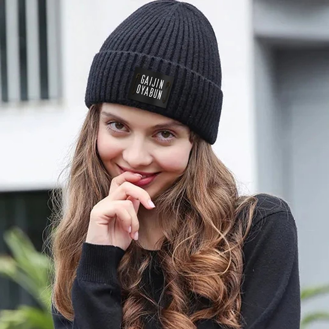 "Trendy black beanie hat. Perfect for cold weather fashion."