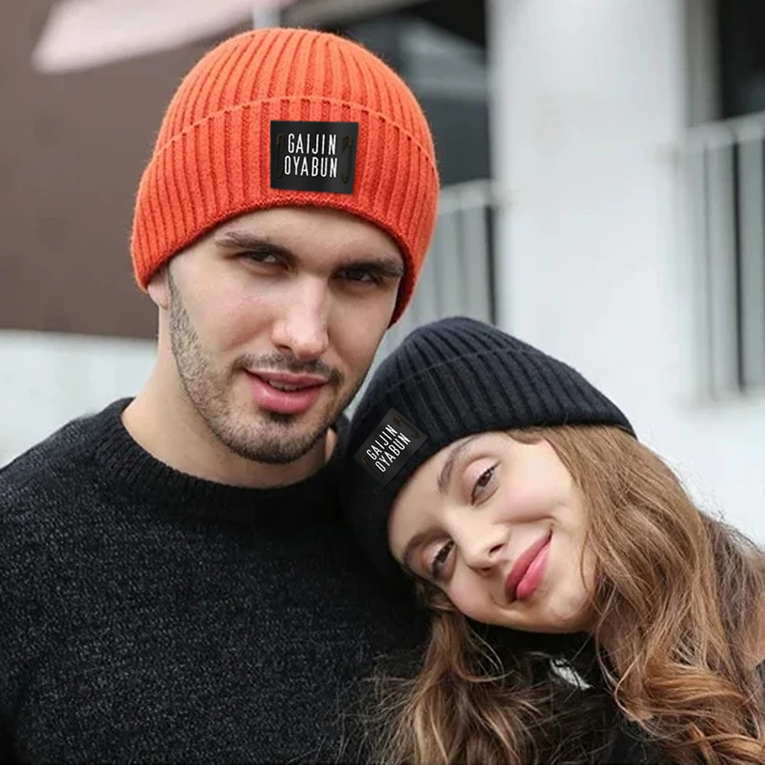 "Trendy orange and black beanie hats. Perfect for cold weather fashion."
